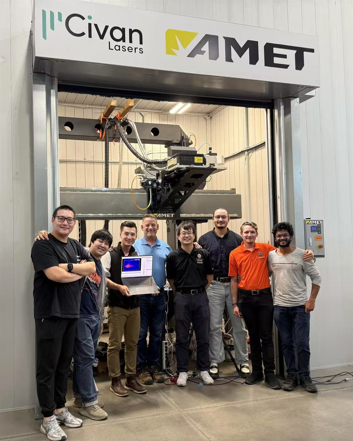 MAML members at AMET with collaborators from Auburn University and UDRI, in front of the Civan laser system